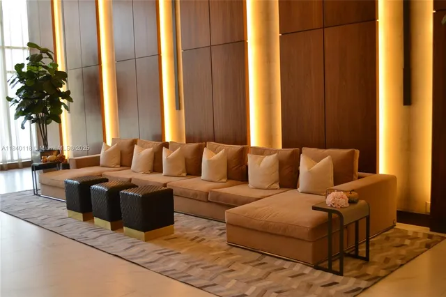 a living room with furniture and a potted plant