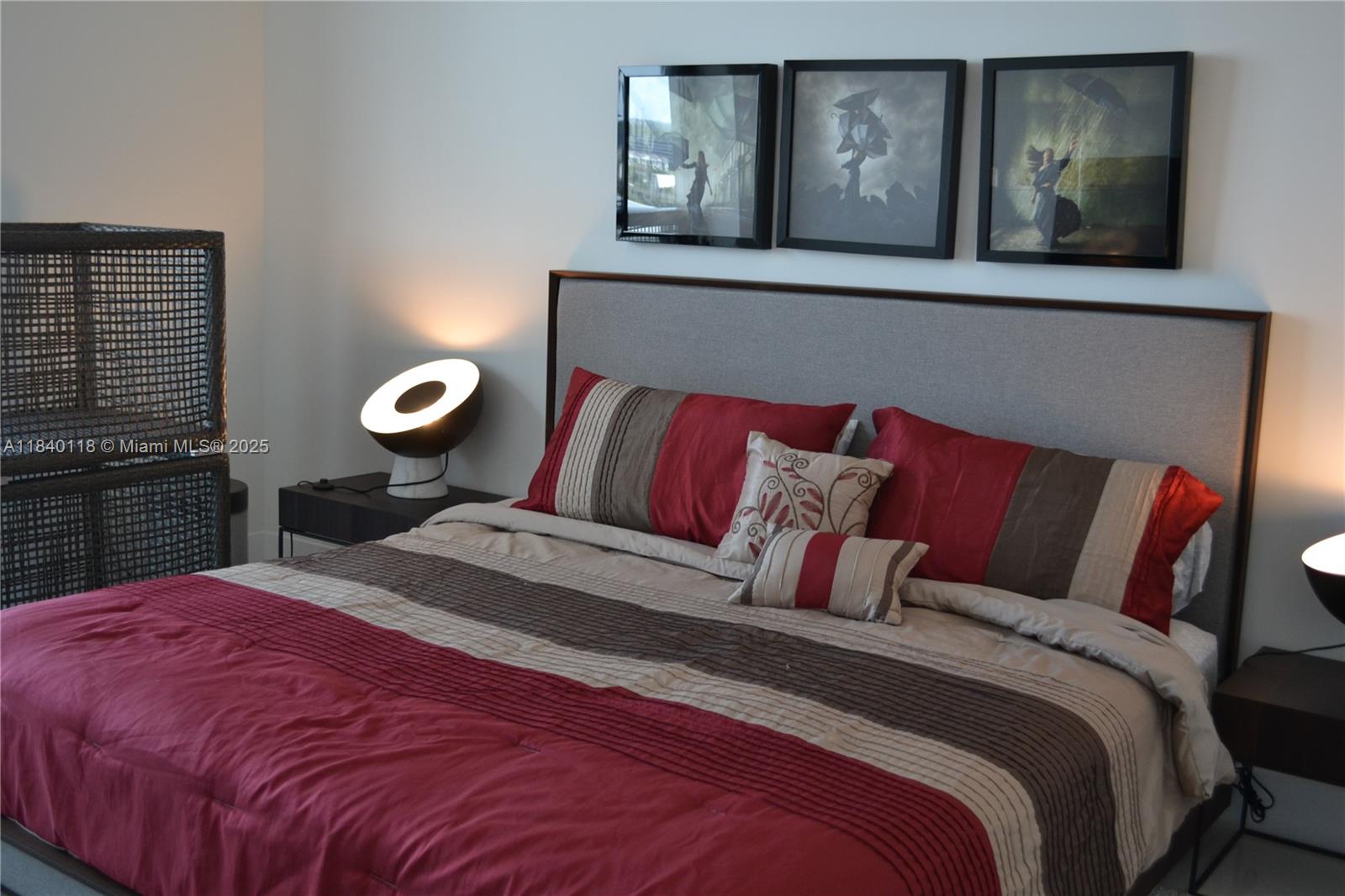 2960 Northeast 207th Street, Unit 1204 Aventura, FL 33180 - Photo 2 of 28 a bedroom with a bed and painting on the wall