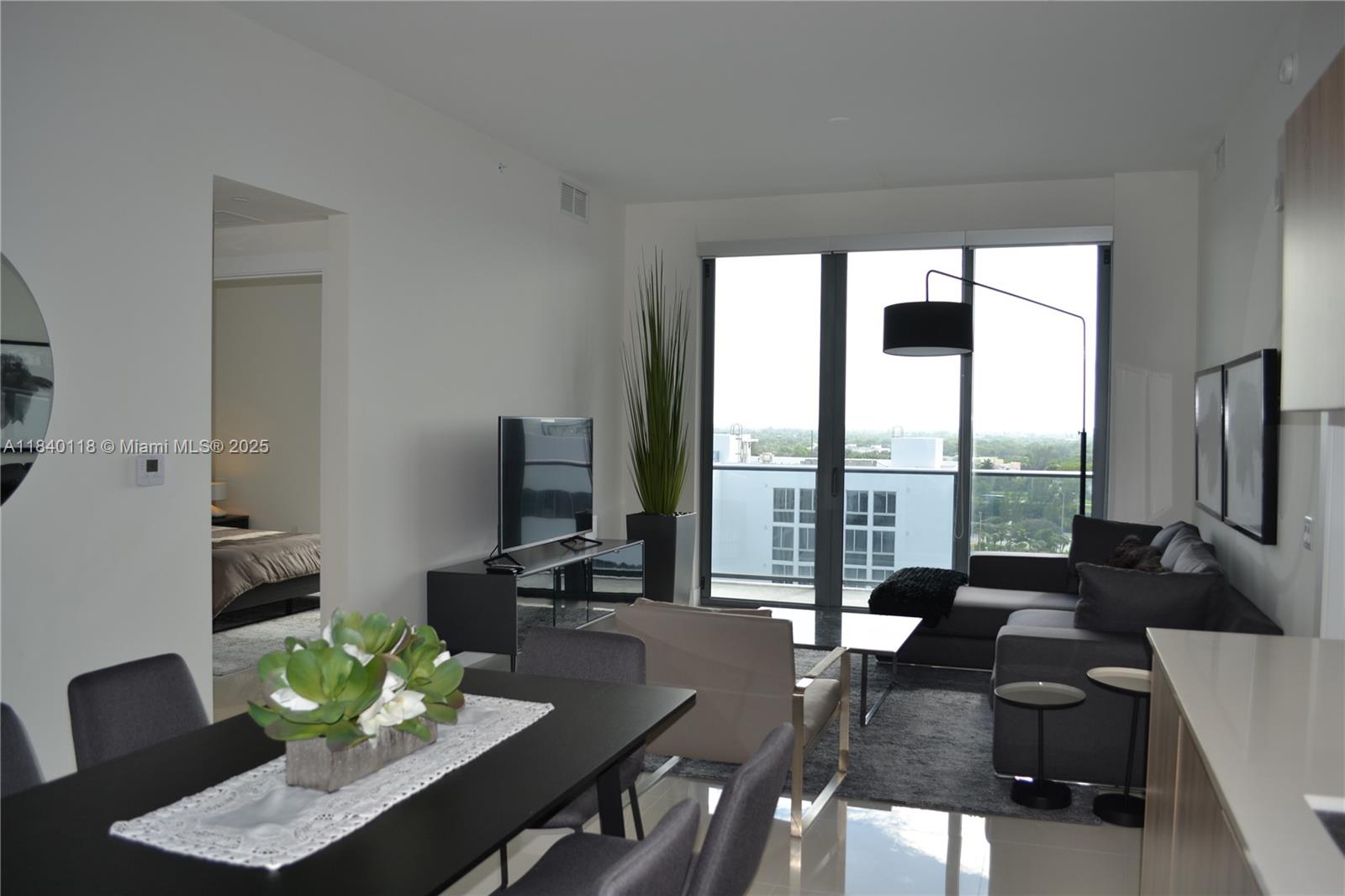 2960 Northeast 207th Street, Unit 1204 Aventura, FL 33180 - Photo 23 of 28 a living room with furniture and a large window