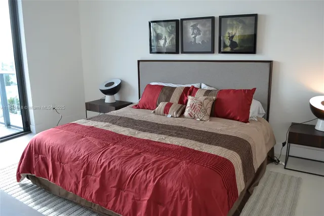 a bedroom with a bed and painting on the wall