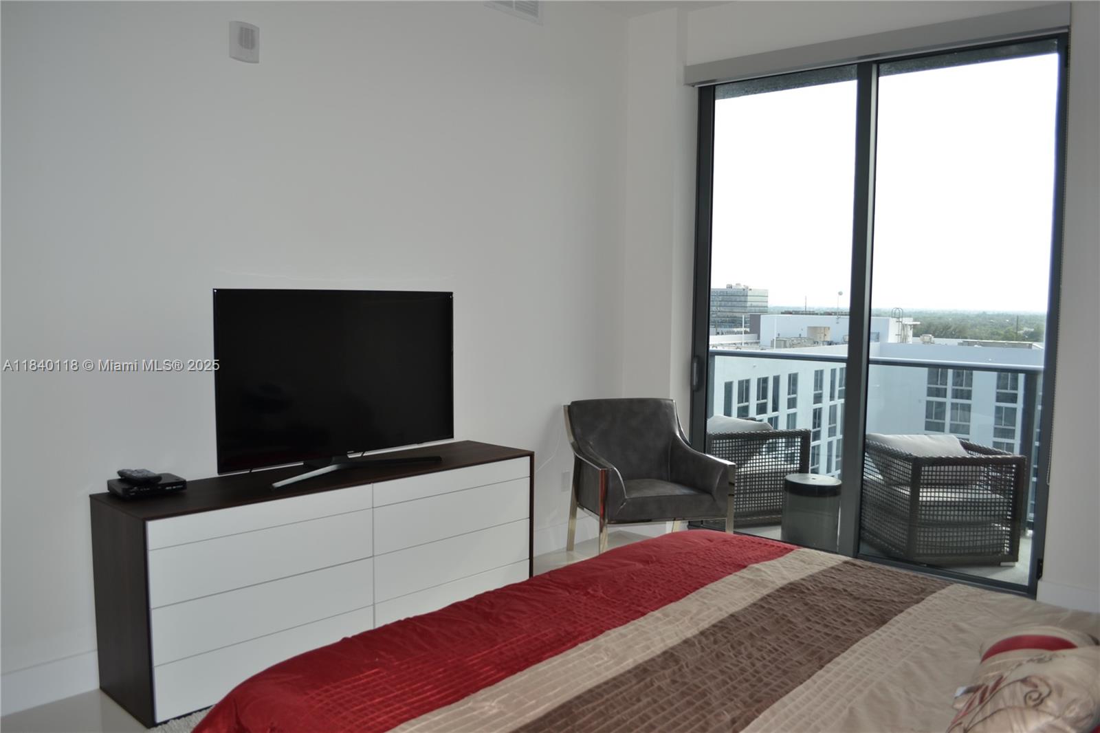 2960 Northeast 207th Street, Unit 1204 Aventura, FL 33180 - Photo 26 of 28 a bedroom with a bed and a flat screen tv