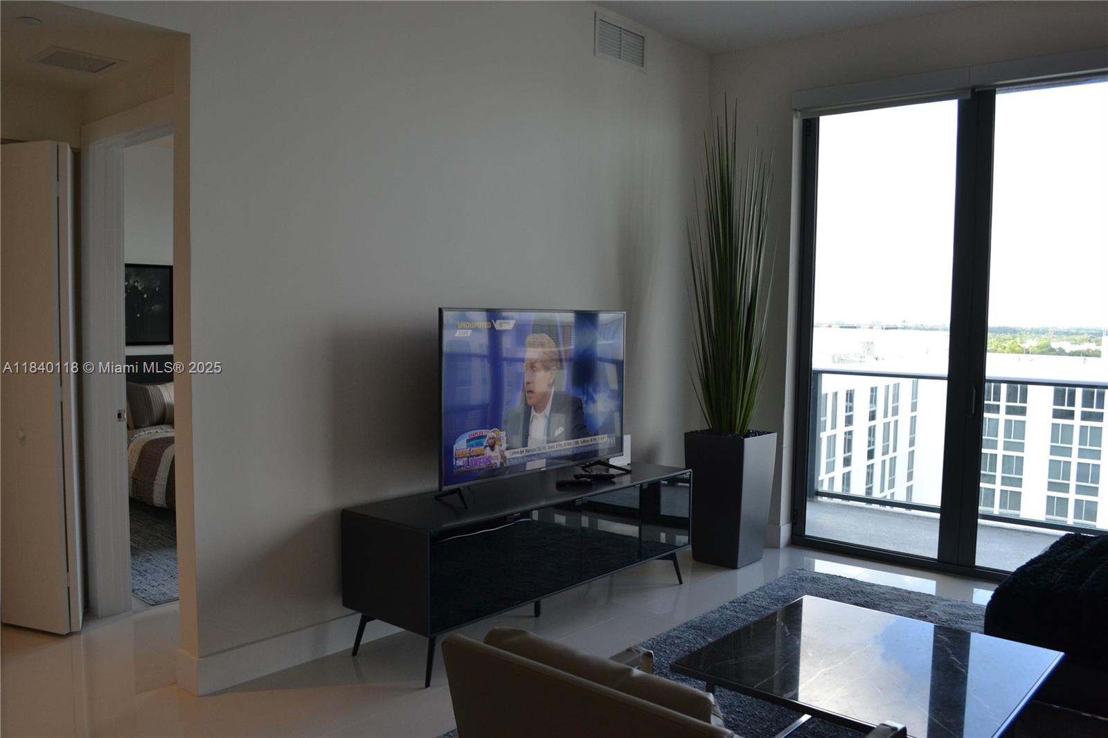 2960 Northeast 207th Street, Unit 1204 Aventura, FL 33180 - Photo 4 of 28 a living room with furniture and a window