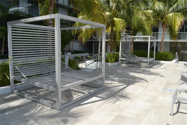 a view of backyard with wheel chair potted plants and palm trees