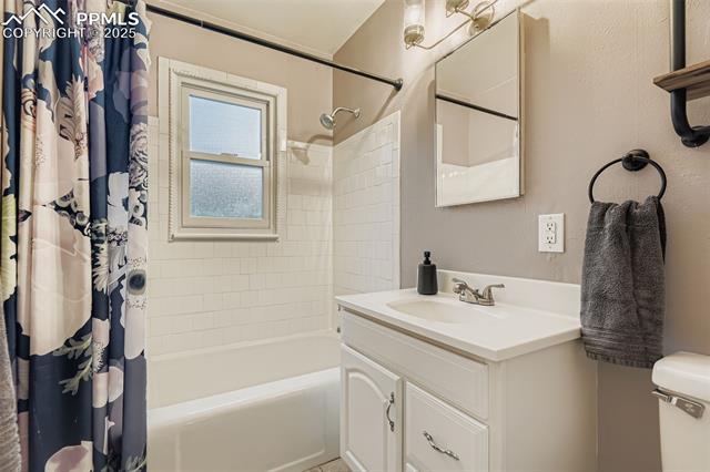 2462 Lafayette Road Colorado Springs, CO 80907 - Photo 15 of 22 Full bathroom featuring shower / bath combination with curtain and vanity