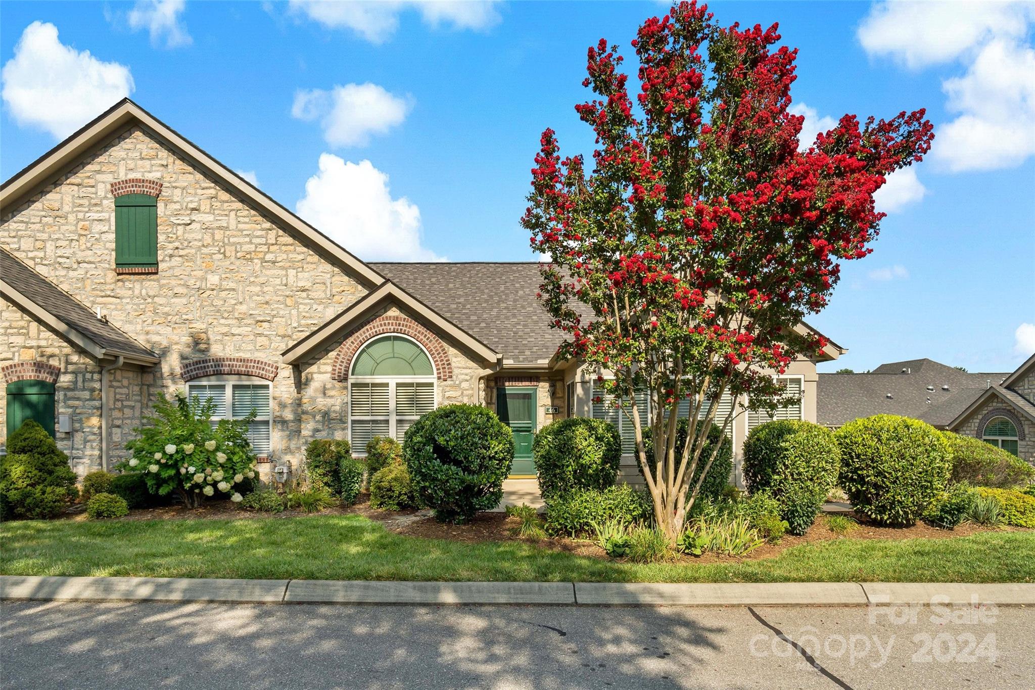 a front view of a house with a garden