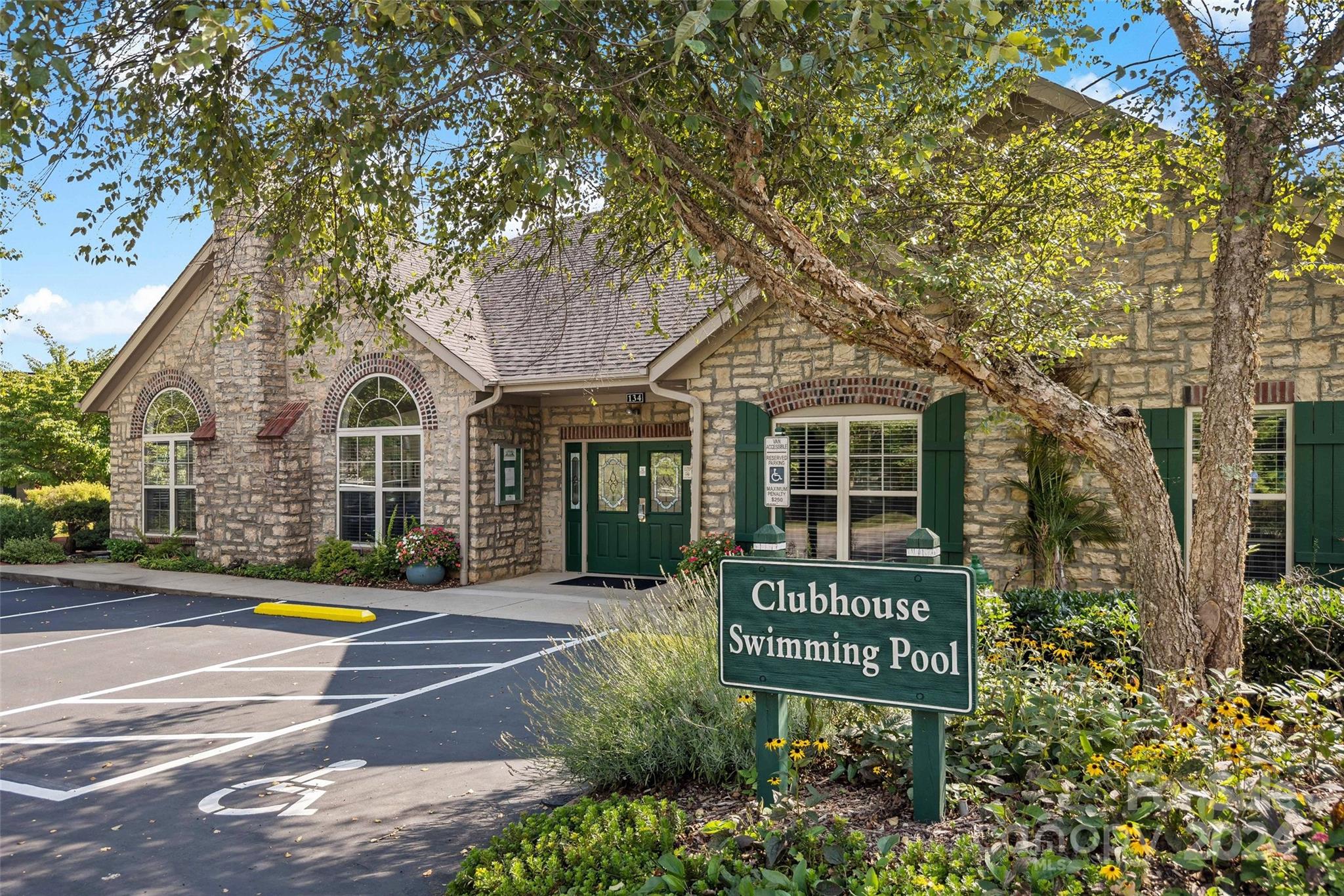 46 Outlook Circle Swannanoa, NC 28778 - Photo 4 of 36 a view of a brick house with large trees and windows