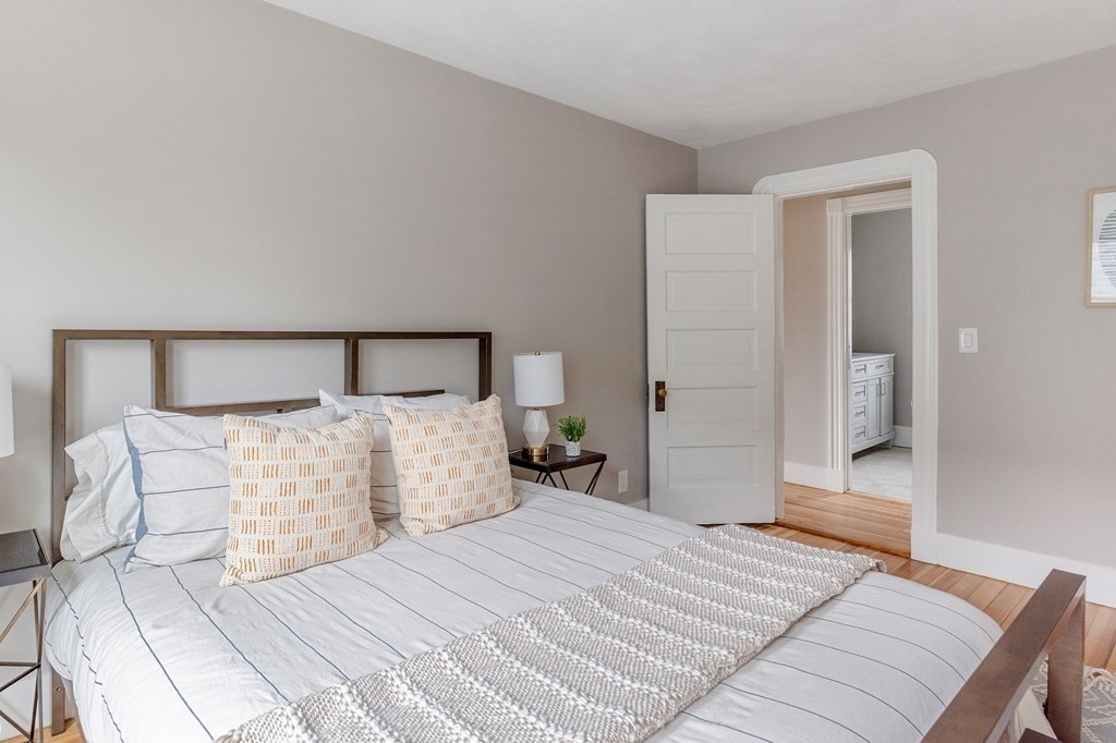 52-54 Gold Star Road Cambridge, MA 02140 - Photo 16 of 36 a bedroom with a large bed and wooden floor