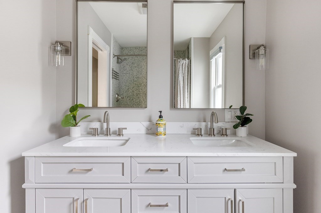 52-54 Gold Star Road Cambridge, MA 02140 - Photo 23 of 36 a bathroom with double sink and a mirror