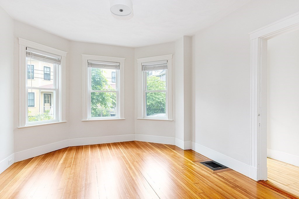 52-54 Gold Star Road Cambridge, MA 02140 - Photo 29 of 36 an empty room with wooden floor and windows