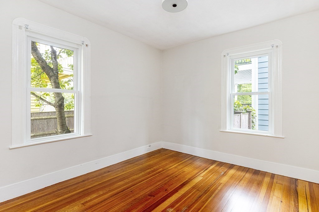 52-54 Gold Star Road Cambridge, MA 02140 - Photo 31 of 36 a view of an empty room with wooden floor and a window