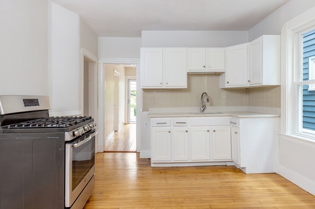 52-54 Gold Star Road Cambridge, MA 02140 - Photo 32 of 36 a kitchen with granite countertop a stove and a sink