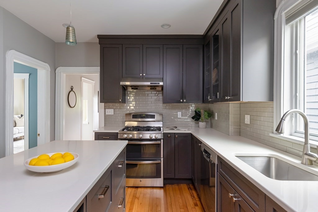 52-54 Gold Star Road Cambridge, MA 02140 - Photo 9 of 36 a kitchen with stainless steel appliances granite countertop a sink stove and refrigerator