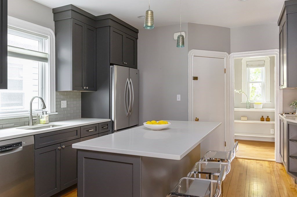 52-54 Gold Star Road Cambridge, MA 02140 - Photo 10 of 36 a kitchen with stainless steel appliances a sink stove and refrigerator