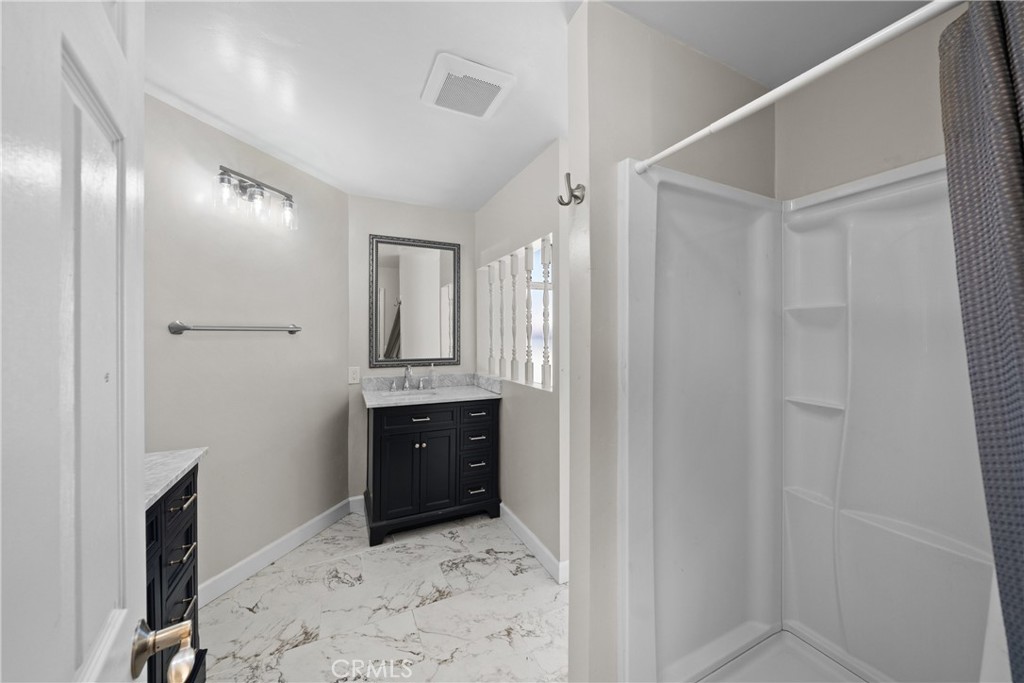 22350 Gavilan Road Perris, CA 92570 - Photo 11 of 34 a spacious bathroom with a granite countertop sink and a mirror