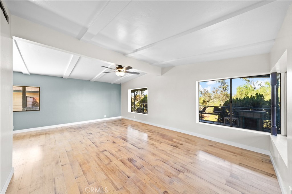 22350 Gavilan Road Perris, CA 92570 - Photo 2 of 34 a view of empty room with wooden floor and fan