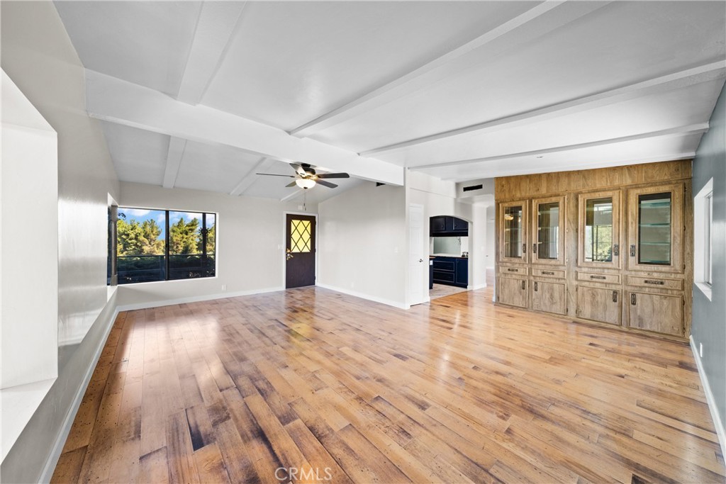 22350 Gavilan Road Perris, CA 92570 - Photo 3 of 34 a view of an empty room with window and wooden floor