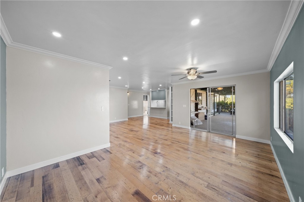 22350 Gavilan Road Perris, CA 92570 - Photo 8 of 34 an empty room with wooden floor and windows