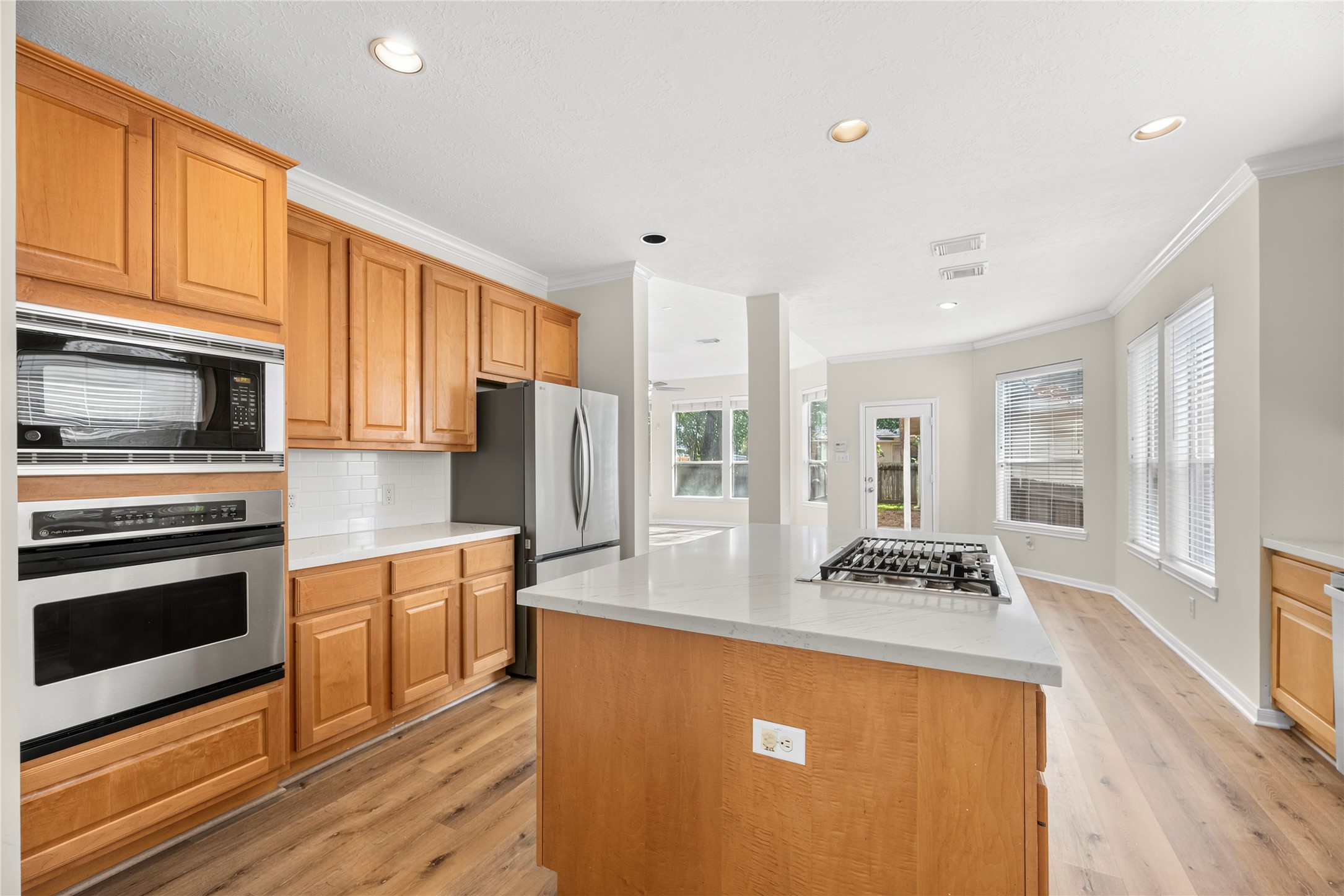 25830 Clear Springs Way Spring, TX 77373 - Photo 8 of 25 Chef's kitchen features a large island, granite countertops, subway tile backsplash, stainless steel appliances and a gas cooktop.
