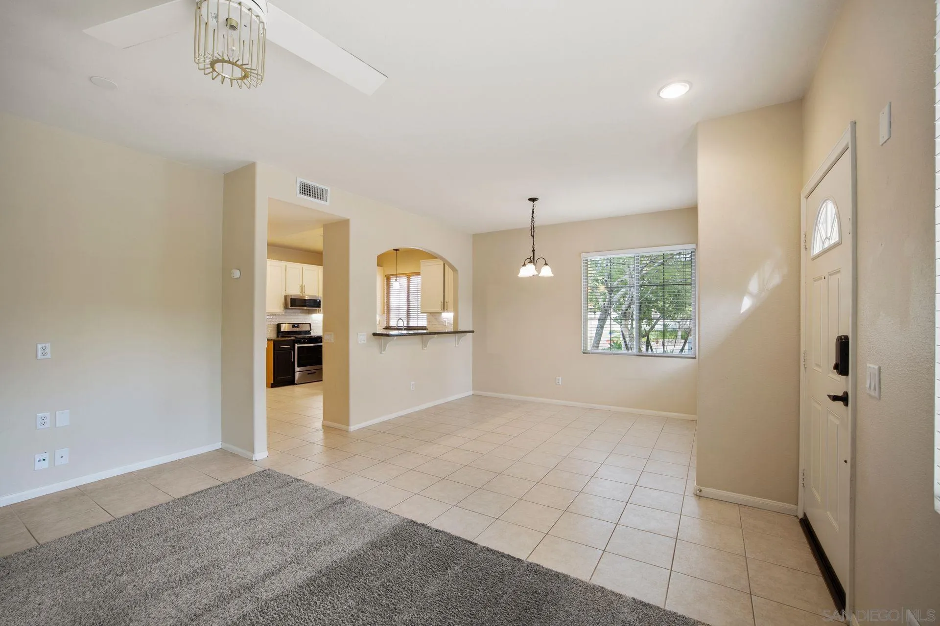4058 Craven Road, Unit 53 Oceanside, CA 92057 - Photo 12 of 31 an empty room with windows and entrance