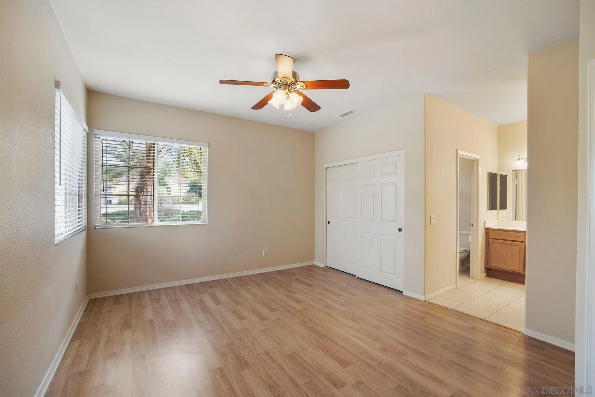 4058 Craven Road, Unit 53 Oceanside, CA 92057 - Photo 20 of 31 wooden floor in an empty room with a window