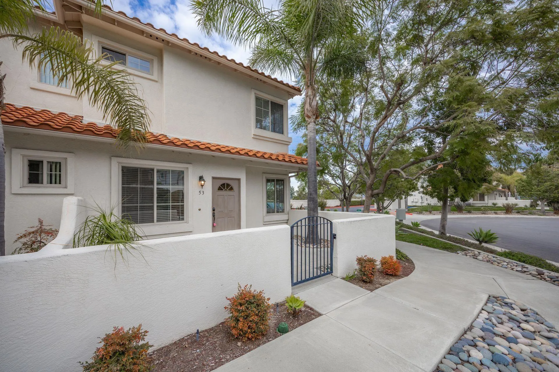 4058 Craven Road, Unit 53 Oceanside, CA 92057 - Photo 2 of 31 front view of house with a yard and potted plants