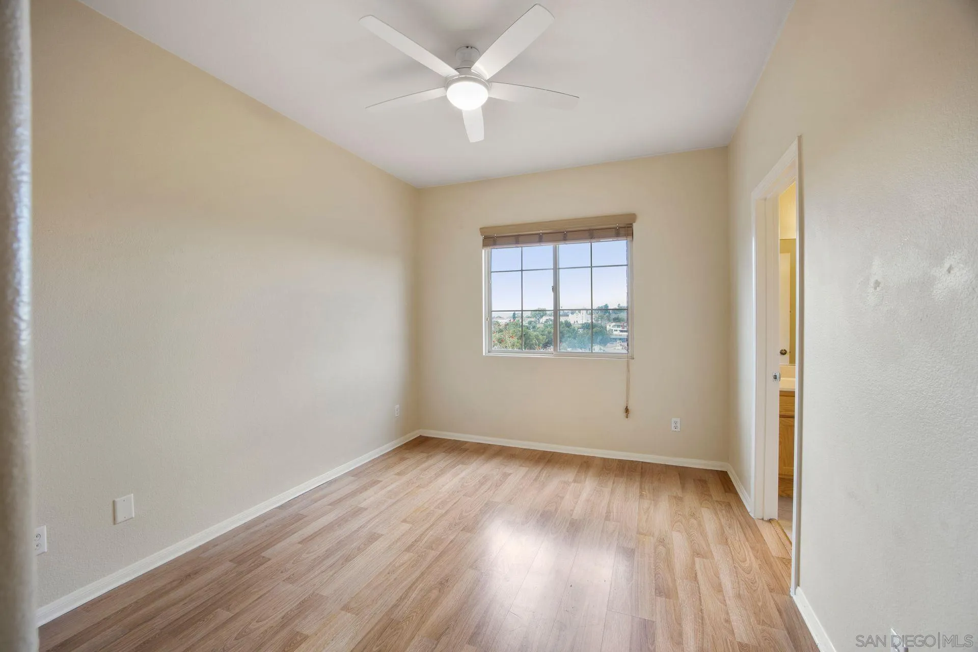 4058 Craven Road, Unit 53 Oceanside, CA 92057 - Photo 22 of 31 an empty room with wooden floor and windows