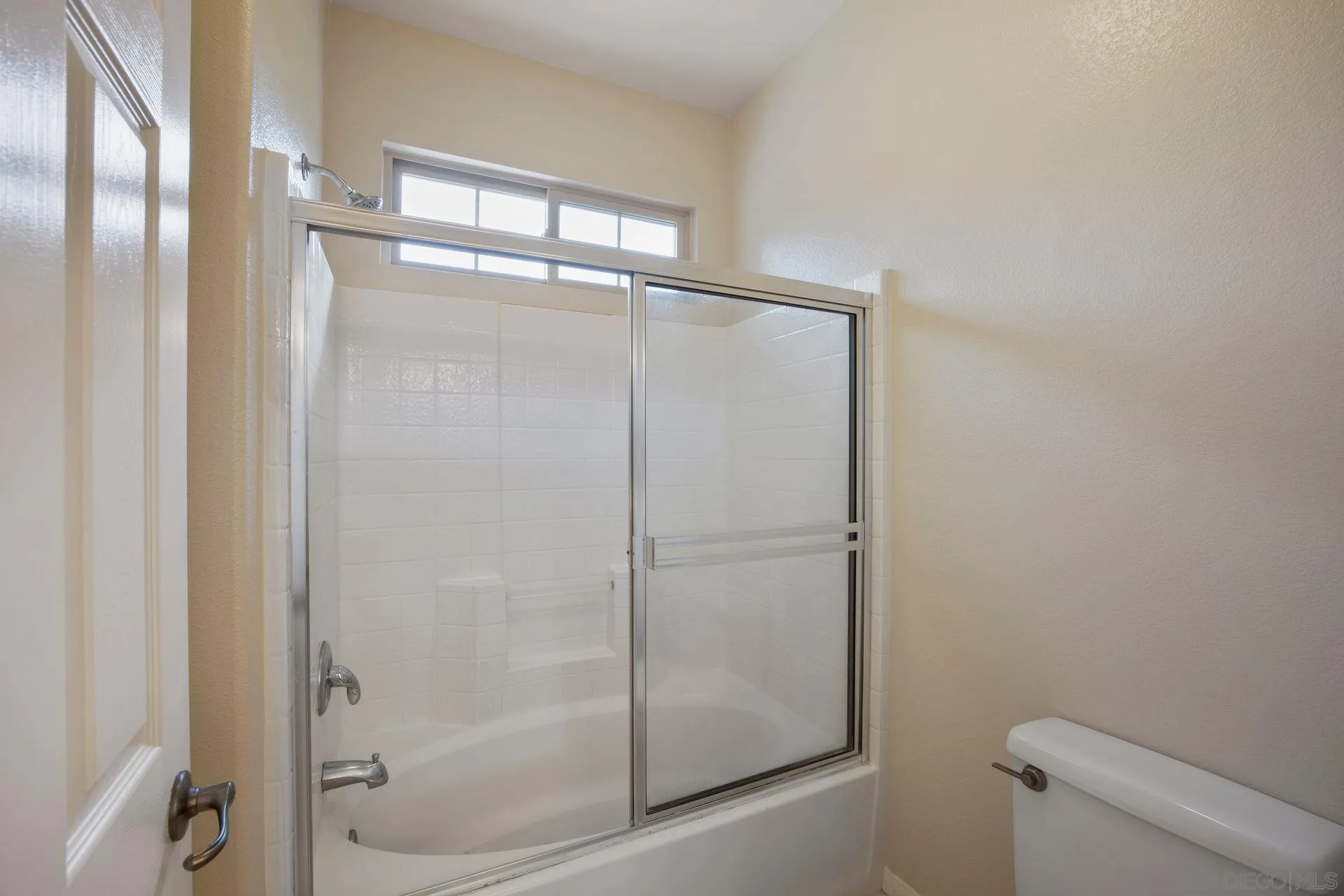4058 Craven Road, Unit 53 Oceanside, CA 92057 - Photo 25 of 31 a bathroom with a glass shower door