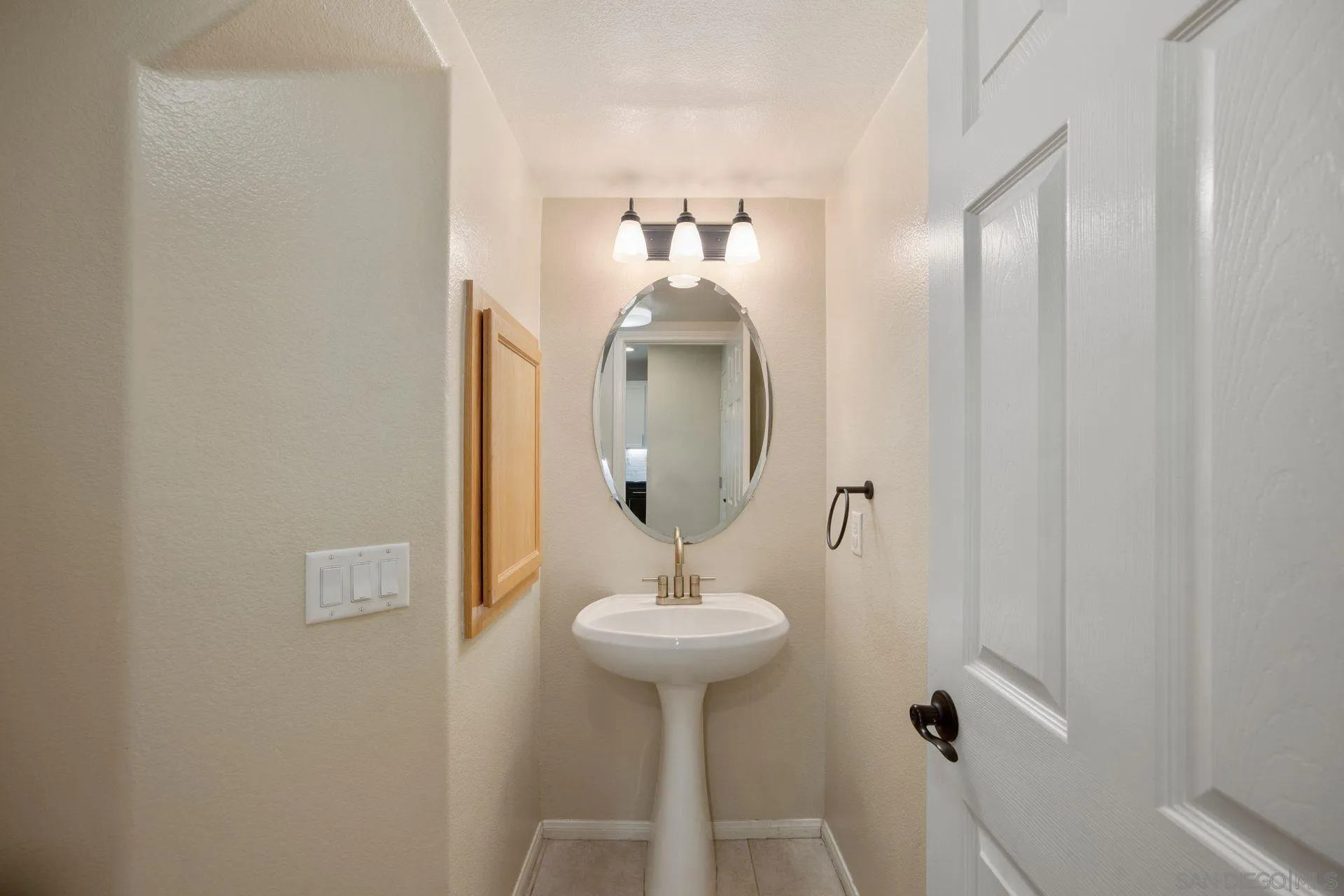 4058 Craven Road, Unit 53 Oceanside, CA 92057 - Photo 26 of 31 a bathroom with a sink and a mirror