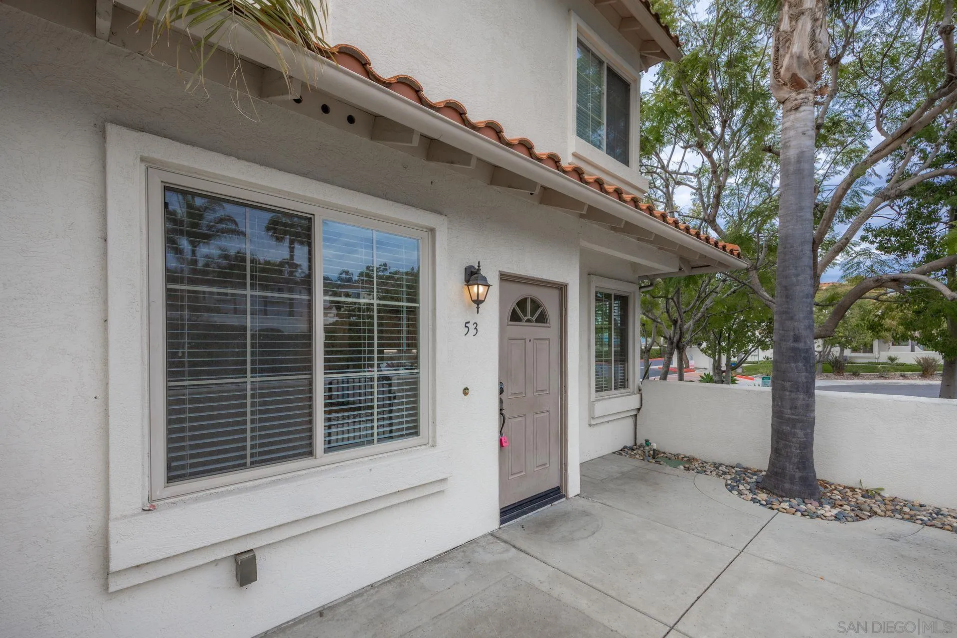 4058 Craven Road, Unit 53 Oceanside, CA 92057 - Photo 3 of 31 a view of backyard with large trees and a large window