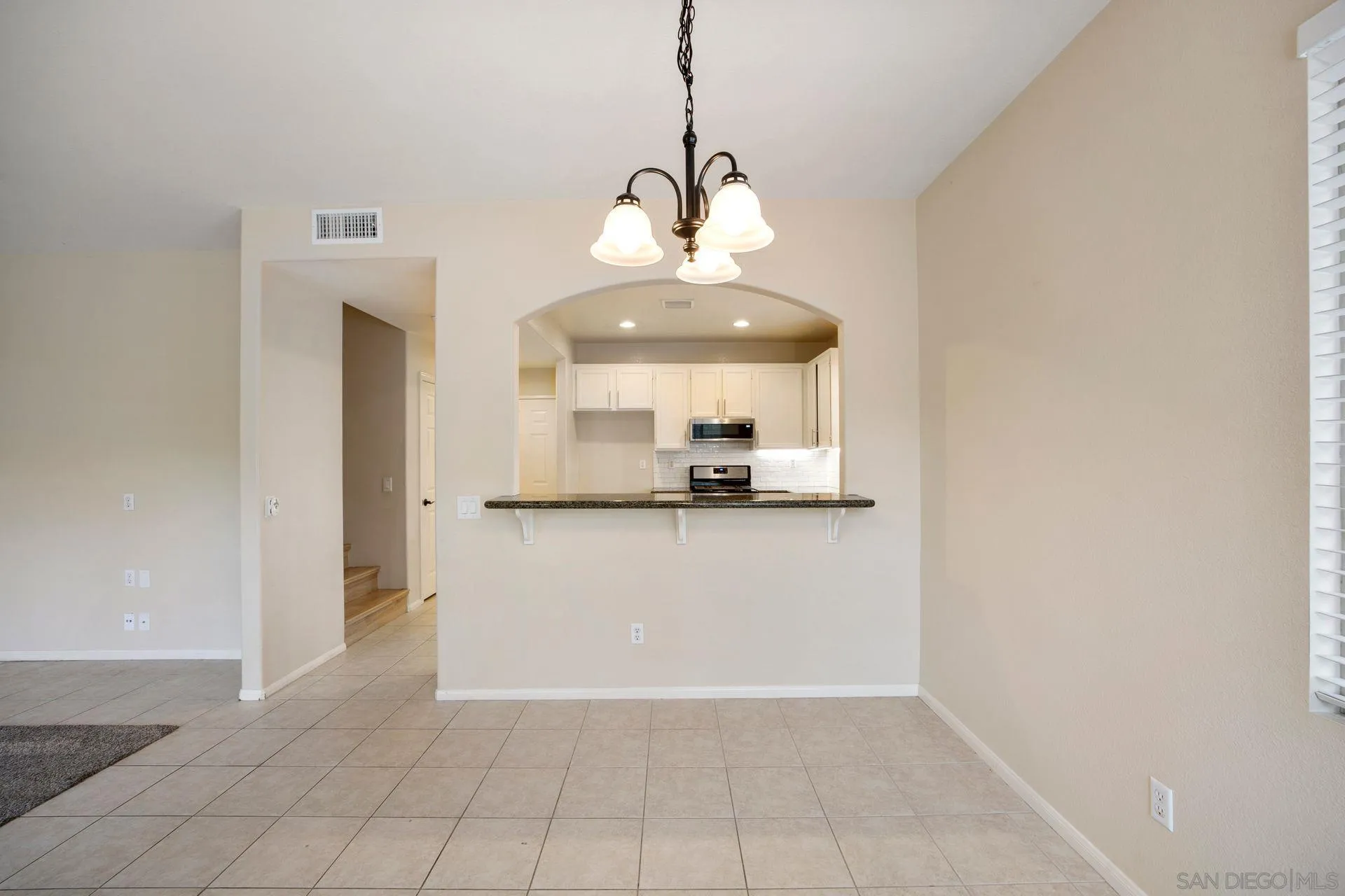 4058 Craven Road, Unit 53 Oceanside, CA 92057 - Photo 9 of 31 a view of a refrigerator in kitchen and an empty room