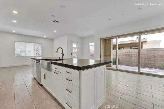 a kitchen with granite countertop a sink and a cabinets