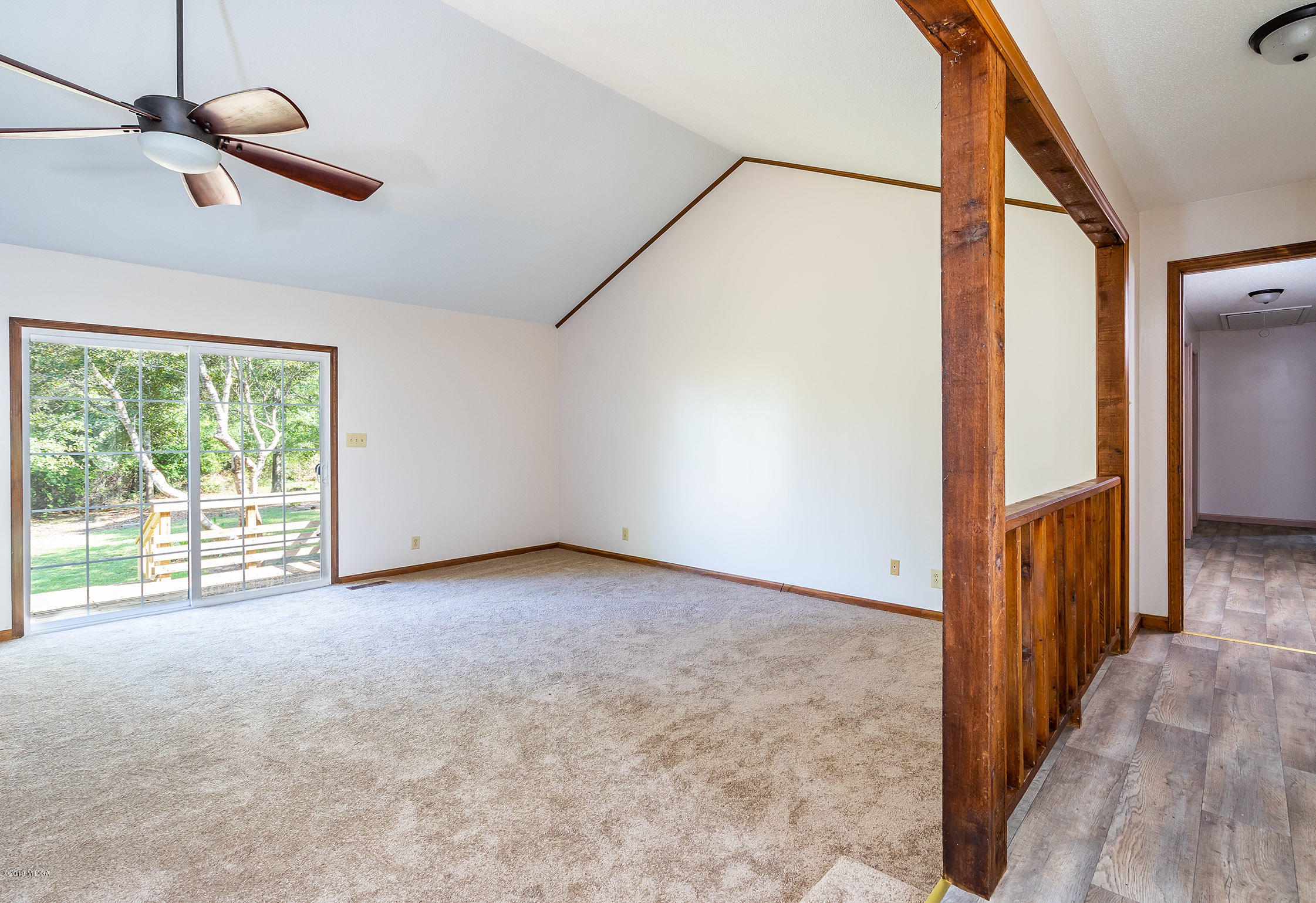 6251 Stapleton Road Macon, GA 31206 - Photo 3 of 21 a view of an empty room with wooden floor and a window