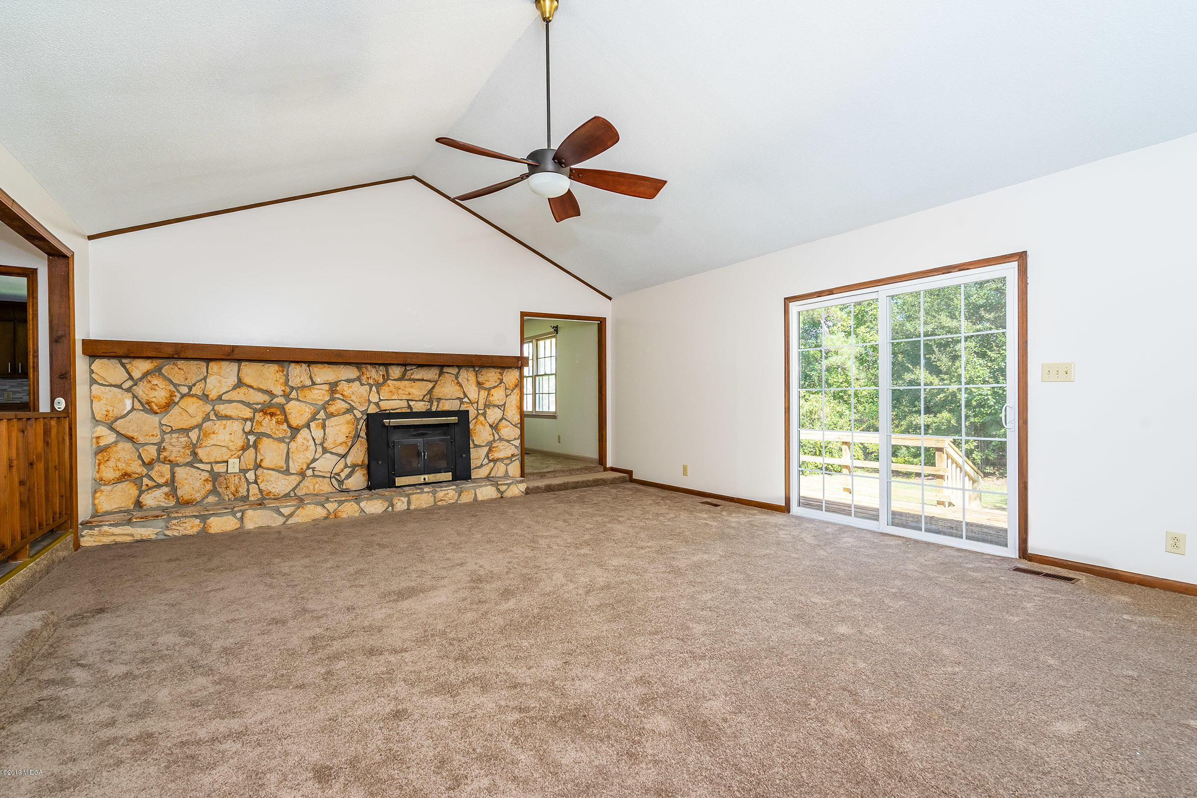6251 Stapleton Road Macon, GA 31206 - Photo 4 of 21 a view of an empty room with fireplace and a window