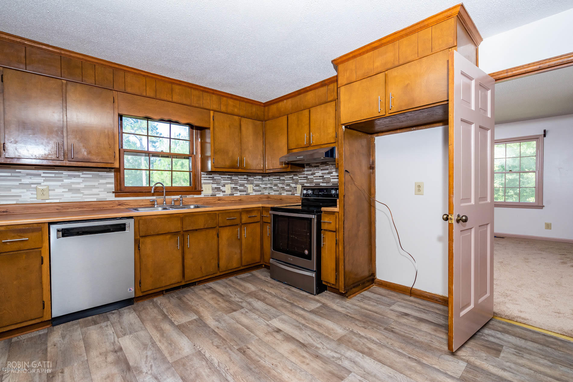 6251 Stapleton Road Macon, GA 31206 - Photo 9 of 21 a kitchen with stainless steel appliances granite countertop a stove a sink and a refrigerator