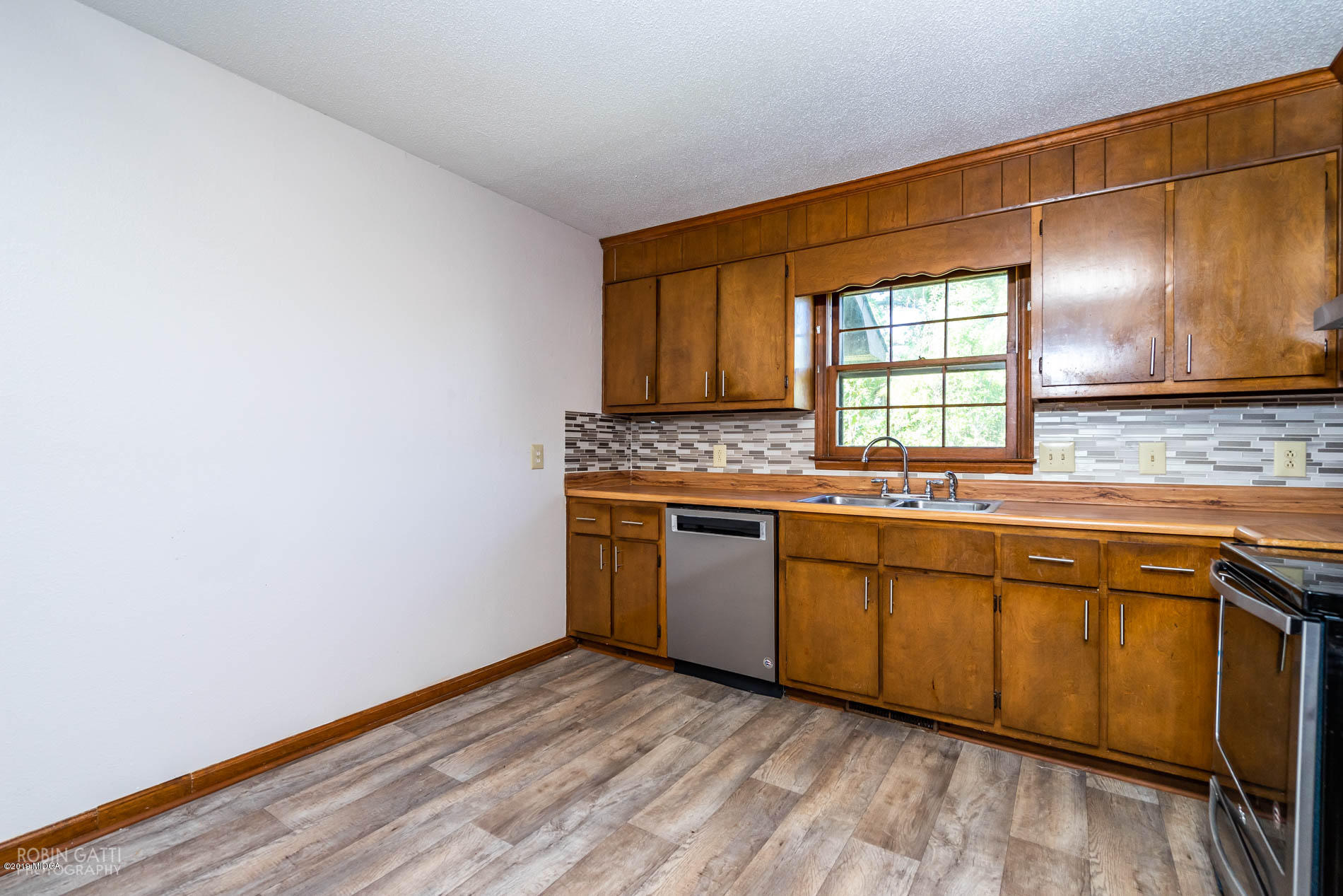 6251 Stapleton Road Macon, GA 31206 - Photo 10 of 21 a kitchen with granite countertop a sink cabinets and wooden floor