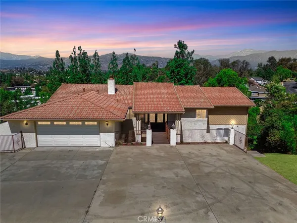 a aerial view of a house with swimming pool garden and patio