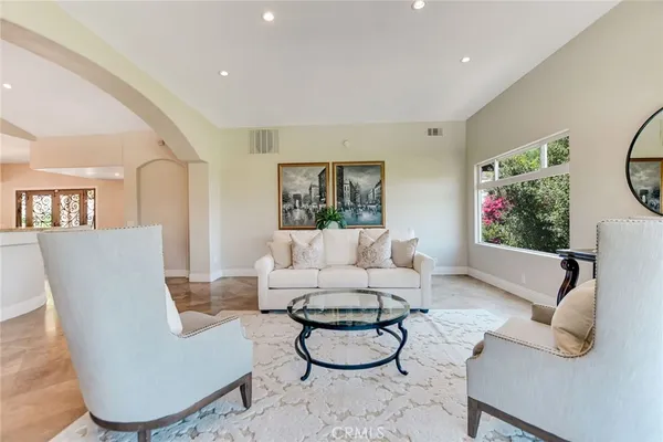 a kitchen with stainless steel appliances granite countertop a refrigerator a stove and a dining table