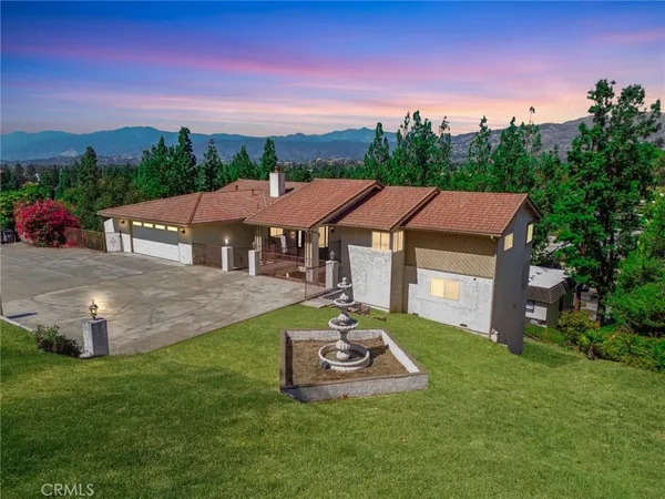 an aerial view of a house with a yard table and chairs