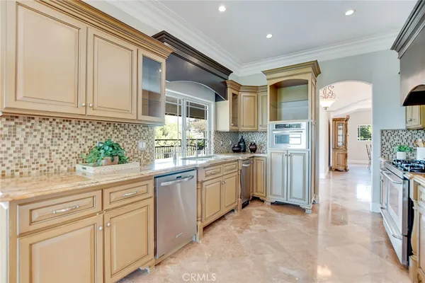 a kitchen with granite countertop a sink and a large window