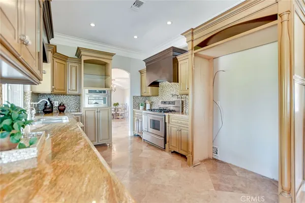 a large kitchen with stainless steel appliances granite countertop a stove and a sink