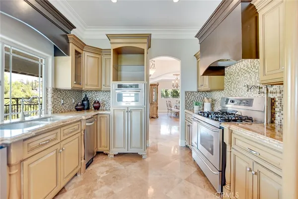 a view of a dining room with furniture a chandelier and wooden floor