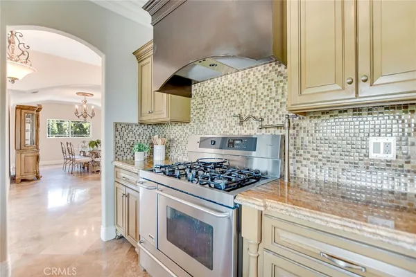 a dining room with furniture a chandelier and wooden floor