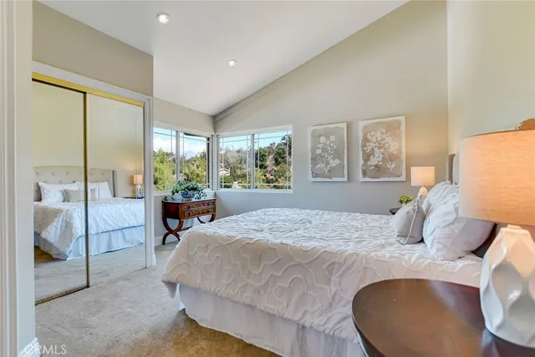 a spacious bedroom with a large bed and a dresser