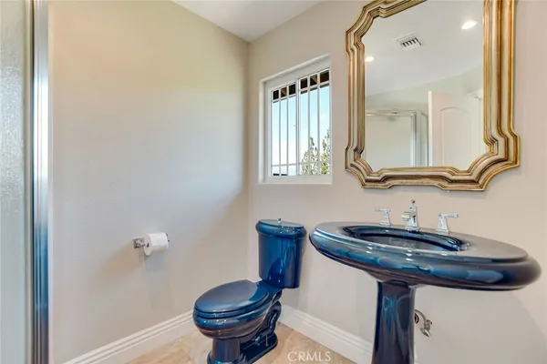 a bathroom with a granite countertop sink a mirror and a window