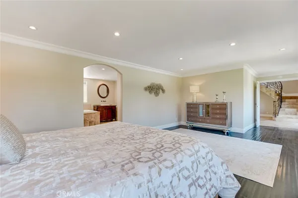 a bathroom with a granite countertop sink a toilet a mirror a bathtub and shower