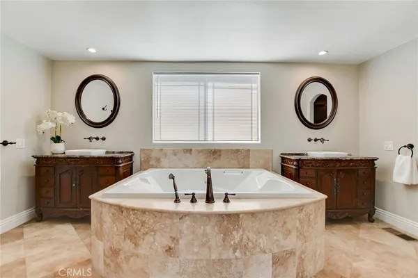 a bedroom with a bed and a potted plant