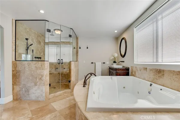 a bathroom with a double vanity sink mirror and shower