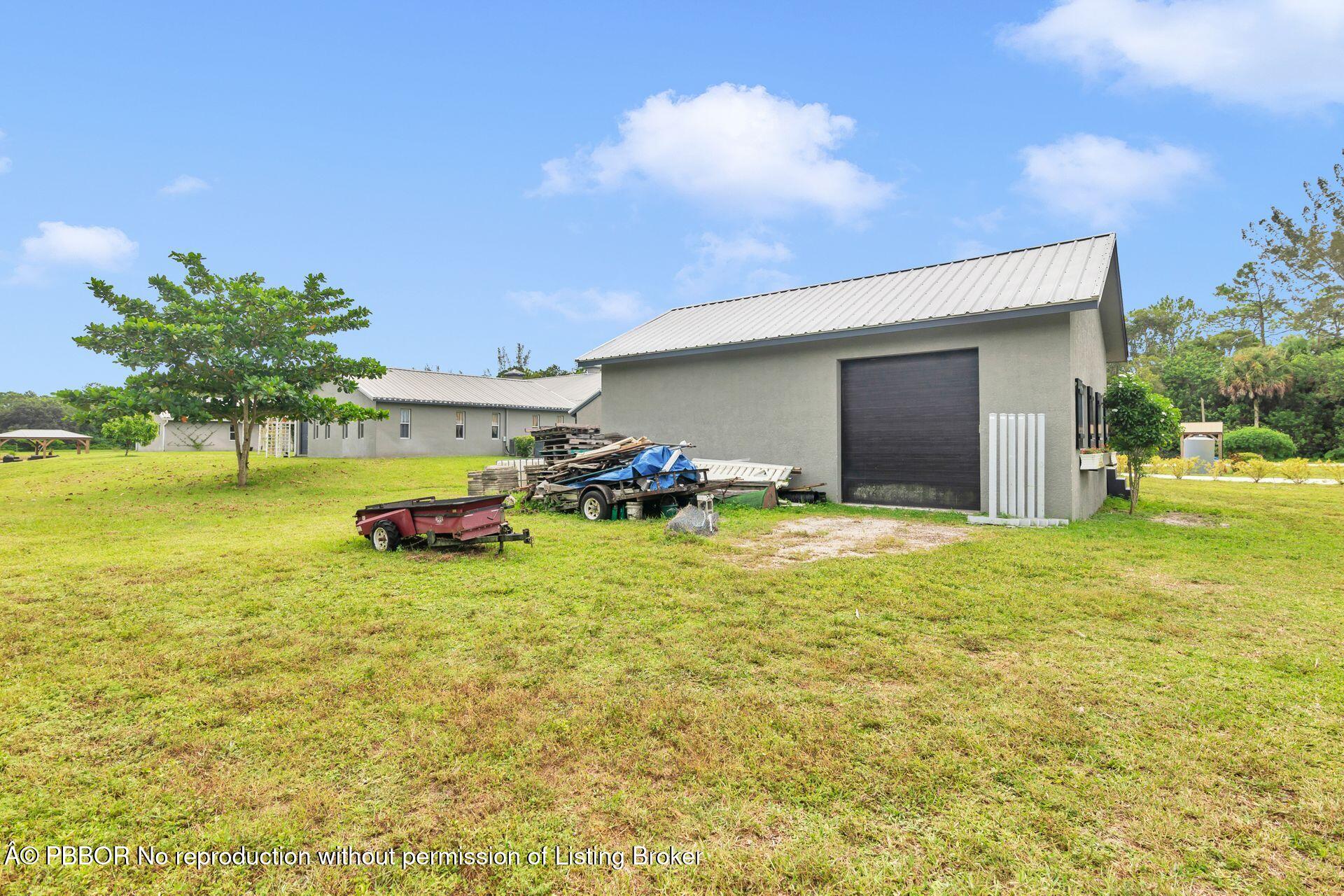 2770 E Road Loxahatchee, FL 33470 - Photo 40 of 51 a backyard of a house with table and chairs