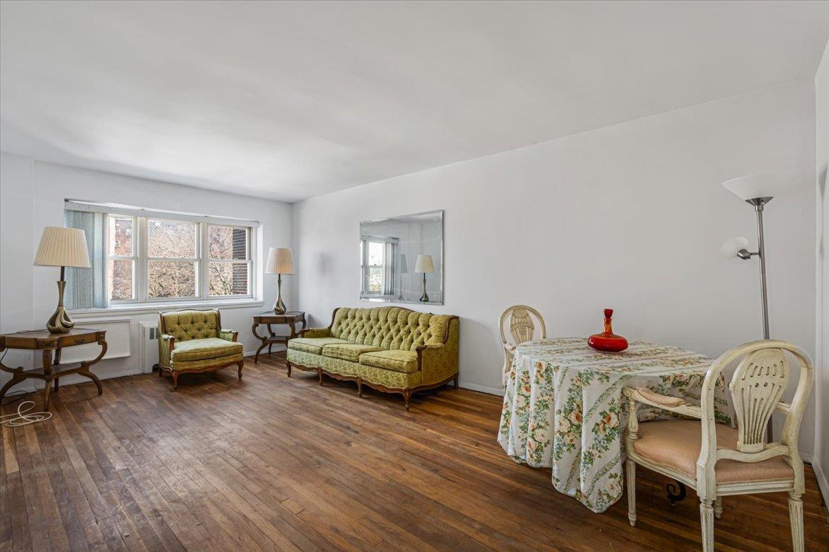 144-55 Melbourne Avenue, Unit 3J Queens, NY 11367 - Photo 3 of 13 Living room featuring a wealth of natural light, baseboards, and hardwood / wood-style floors