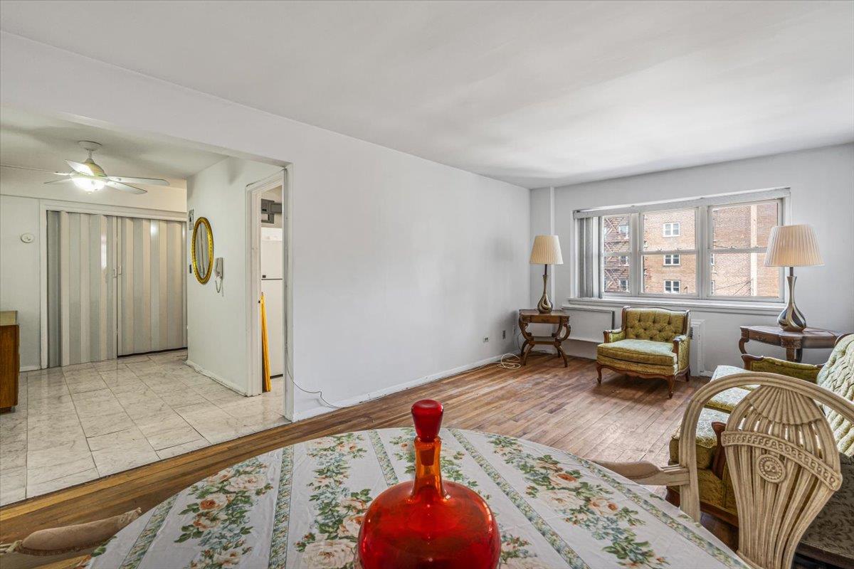 144-55 Melbourne Avenue, Unit 3J Queens, NY 11367 - Photo 4 of 13 Living area featuring baseboards, ceiling fan, and wood finished floors